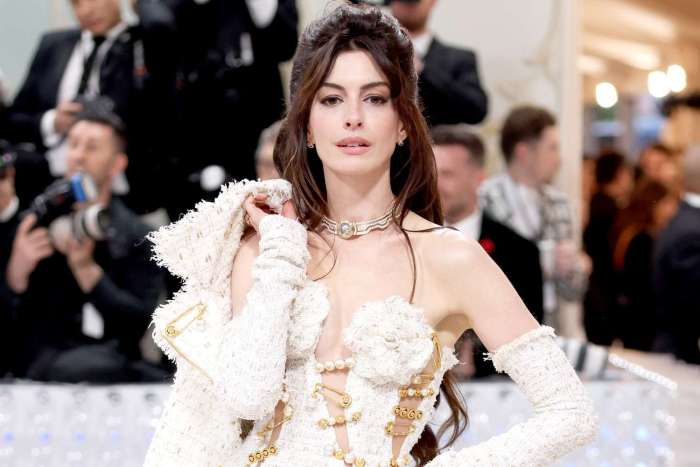 See anne hathaway jump on two big fashion tends as she rocks a hooded ensemble and a see through gown
